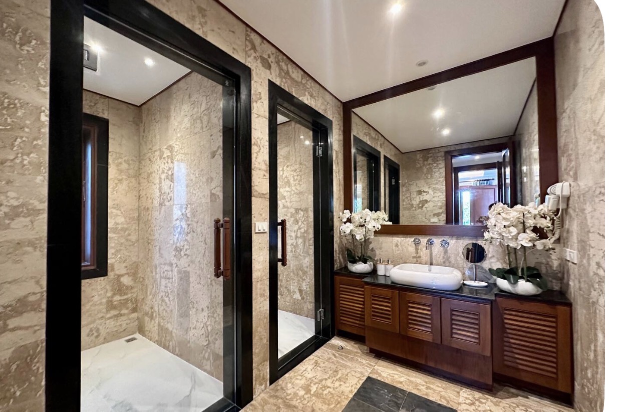 Second bathroom with walk-in rain shower and orchid-topped vanity