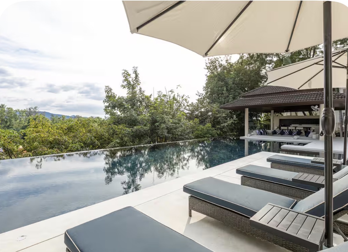Sun loungers and umbrellas along the villa's infinity pool