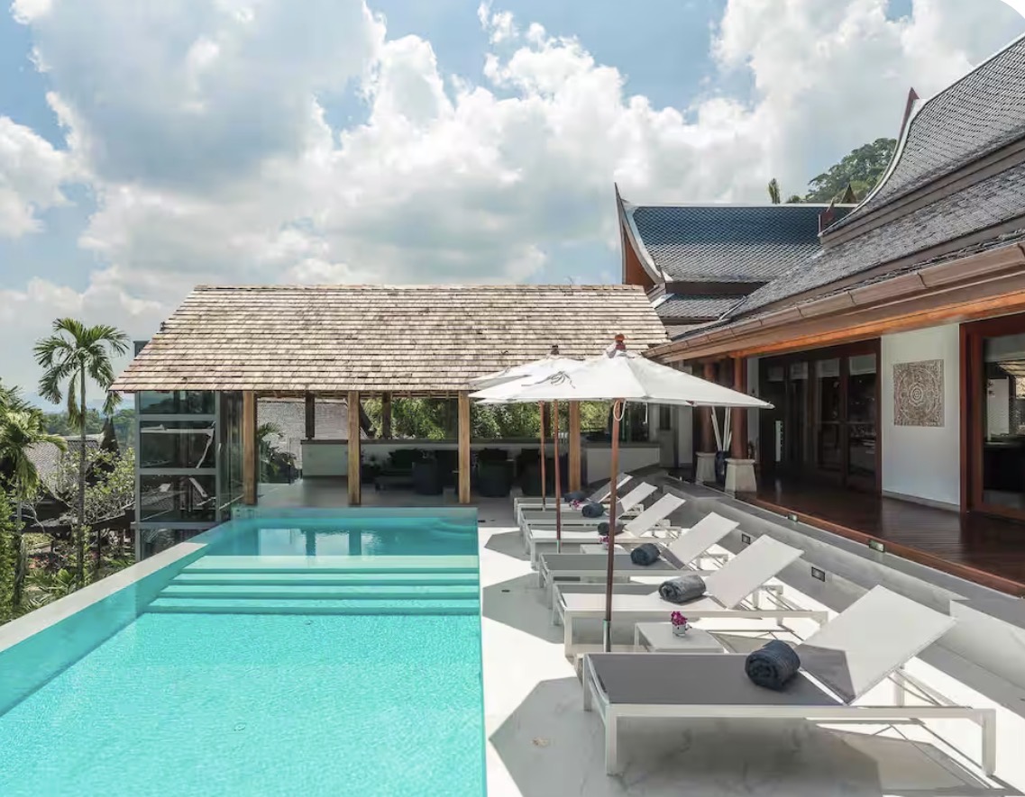 Sunset over a luxury villa infinity pool in Phuket
